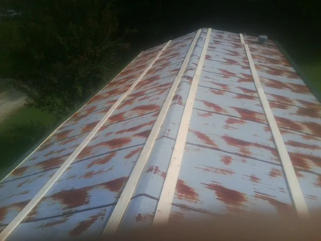 Rusted metal roof panels with new wood purlins before replacement — Storm Damage Roof Repair in Bradner by Roofing Brothers